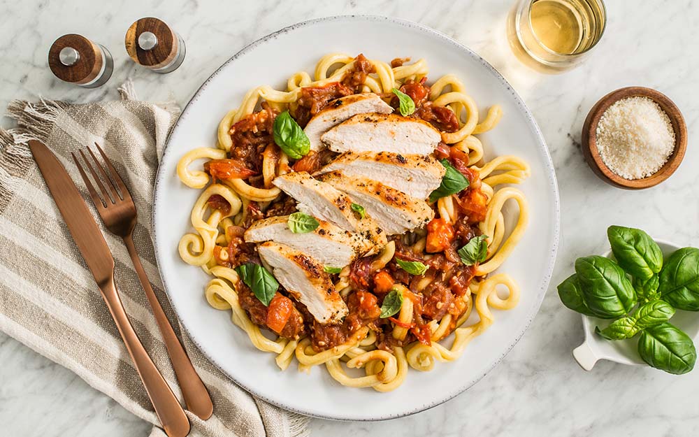 Bruschetta Chicken Pasta with balsamic-fig tomato sauce and grana padano cheese,