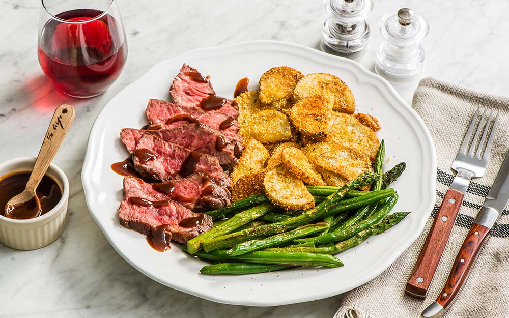 Maple Chipotle Steak with cornmeal-crusted potatoes, asparagus and beans,