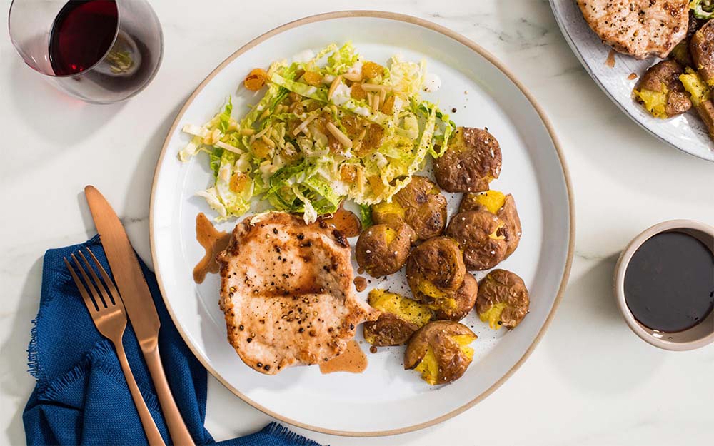 Seared Pork & Pomegranate Sauce with roasted red potatoes, almonds and golden raisins,