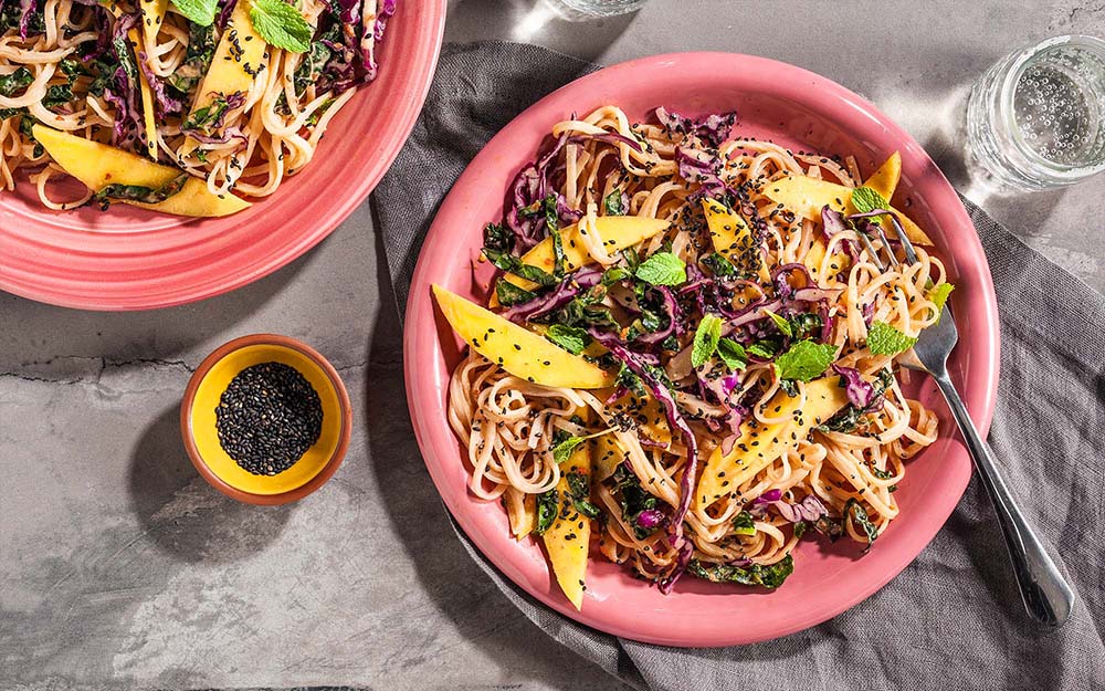Malaysian Mango Noodles with a spicy tahini-chili sauce and black sesame,